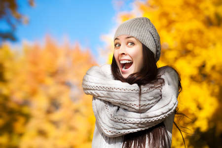 funny cheerful girl on a background of autumn treesの写真素材
