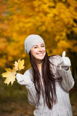 happy cheerful woman on a background of autumn treesの写真素材