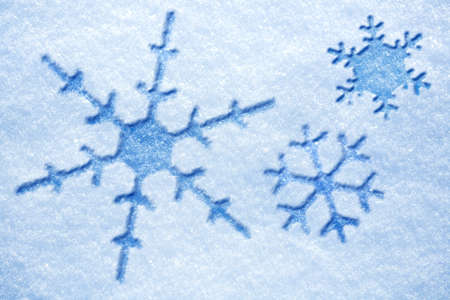 blue snowflakes on a snowy backgroundの写真素材