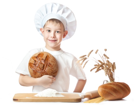 cute baker boy with a loaf of rye breadの写真素材