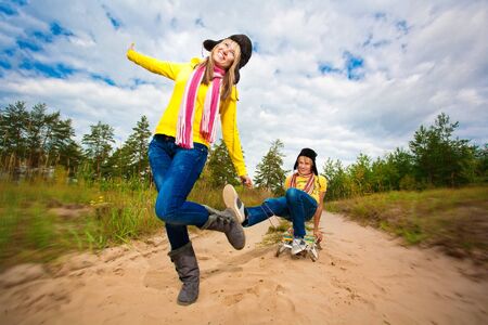 Funny couple are sledding at summerの写真素材
