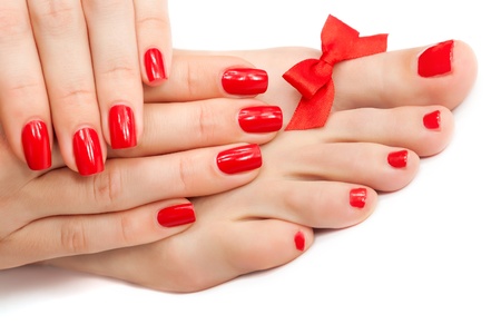 Relaxing Red manicure and pedicure with a bow  isolatedの写真素材
