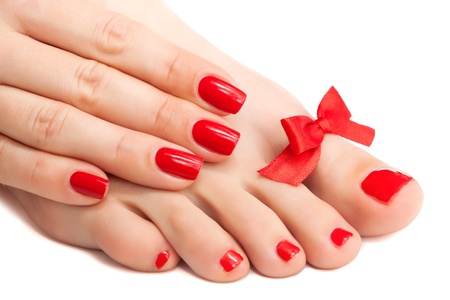 Red manicure and pedicure with a bow  isolatedの写真素材