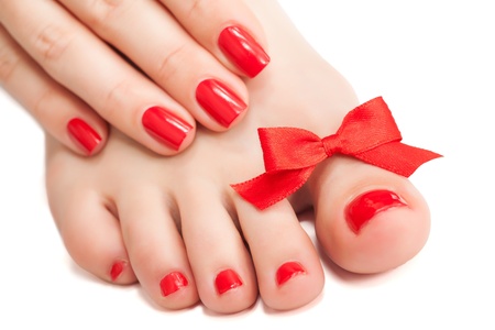 Red manicure and pedicure with a bow  isolatedの写真素材
