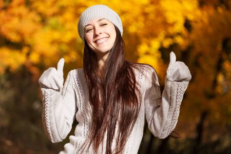 cute cheerful girl on a background of autumn treesの写真素材