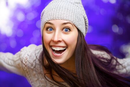happy girl in hat on a winter backgroundの写真素材