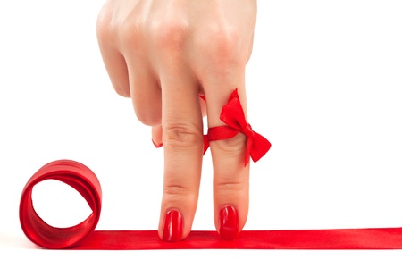 two female fingers with red manicure as a legs on the red carpetの写真素材