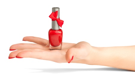 woman s hand with a bottle of red nail polishの写真素材