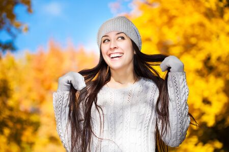 cute cheerful girl on a background of autumn treesの写真素材
