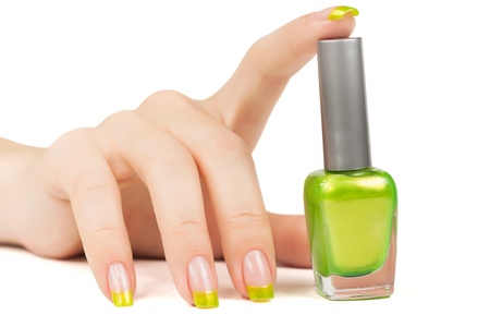 woman's hand with a bottle of green nail polish. isolatedの写真素材