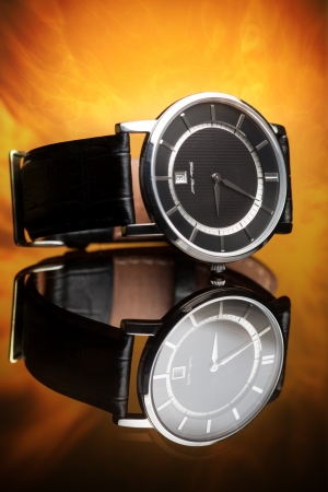 watches with a leather strap on a flame backgroundの写真素材