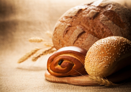 rye bread and pastries on burlap backgroundの写真素材