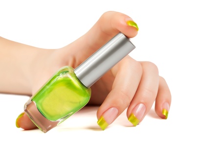 woman s hand with a bottle of green nail polishの写真素材
