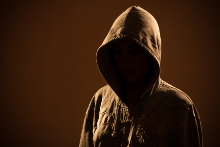 Scary woman with hood in darknessの写真素材