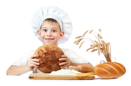 happy baker boy with a loaf of rye breadの写真素材