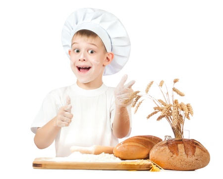 funny little kid is kneading doughの写真素材