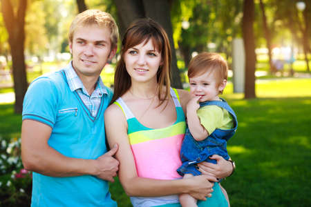 portret baby with parents in a beautiful summer parkの写真素材