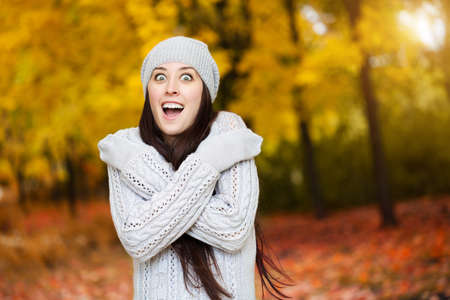 happy woman in a yellow autumn parkの写真素材