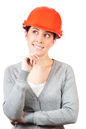 Young woman with orange hard hat on whiteの写真素材