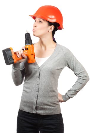 Young woman with orange hard hat on whiteの写真素材