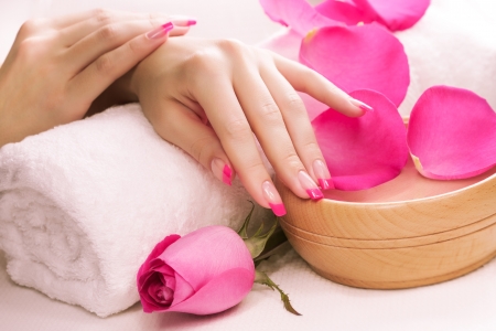 beautiful manicure with fragrant rose petals and towelの写真素材
