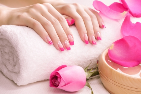 female hands with fragrant rose petals and towelの写真素材