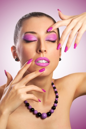 Beautiful young woman with pink make-upの写真素材