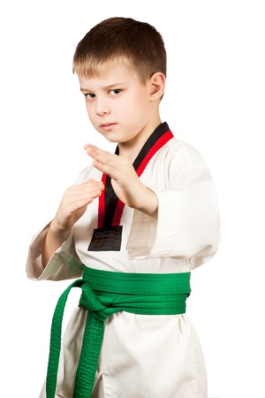 Young boy training karate. Isolated on white backgroundの写真素材