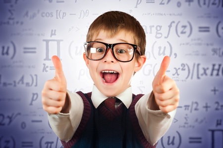 small kid in glasses on the formulas backgroundの写真素材