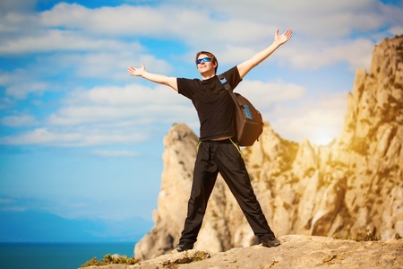 tourist is enjoying landscape with outstretched armsの写真素材