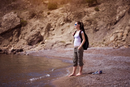 pretty woman is walking along the beach  tourismの写真素材