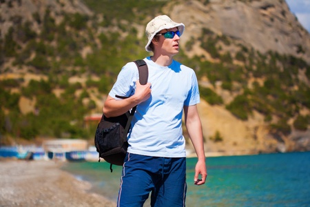 man in Panama hat is walking on the beachの写真素材