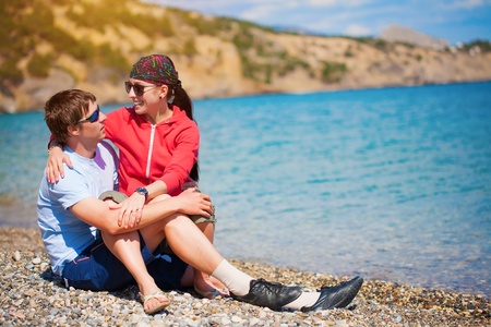  happy couple are sittting on the beachの写真素材