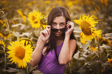 pretty woman in a sunflower's fieldの写真素材