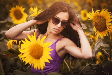 pretty woman in a sunflower's fieldの写真素材