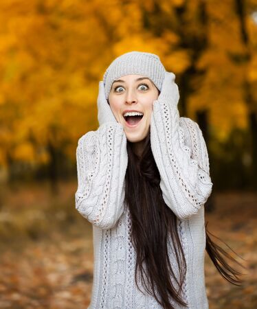 happy girl in a yellow autumn parkの写真素材