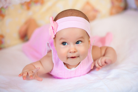 baby girl in a pink dressの写真素材
