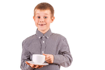 cute boy with white cup of teaの写真素材