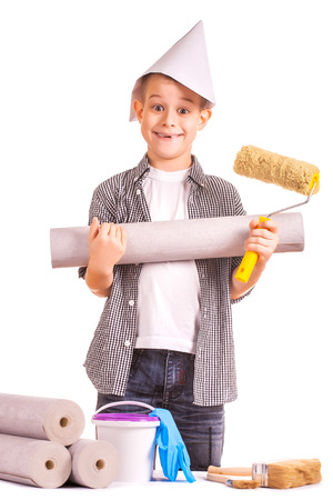 little boy with wallpaper and paint rollerの写真素材