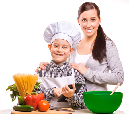 mother and som are cooking on the kitchenの写真素材