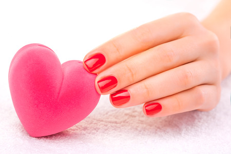 Closeup red manicure on the white towelの写真素材