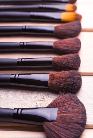 Set of black make-up brushes in row