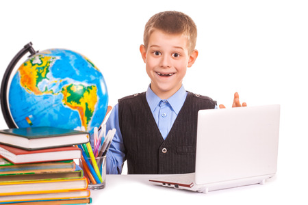 schoolboy with books and laptop on a white backgroundの写真素材