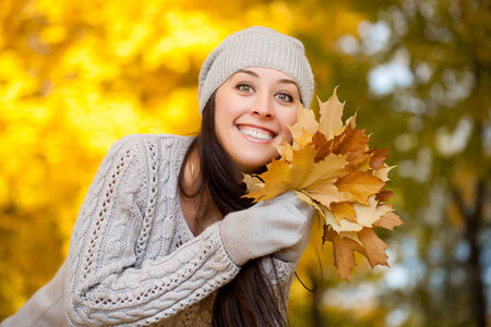 Young pretty woman walking in the autumn parkの写真素材