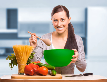 happy woman is cooking. isolatedの写真素材
