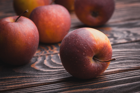 fresh red apples on wooden table, selective focusの写真素材