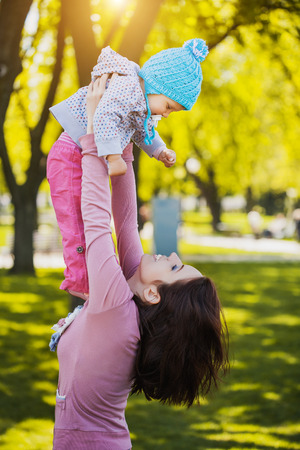 Mother And Baby outdoors. Nature. Beauty Mum and her Child playing in Park together.の写真素材