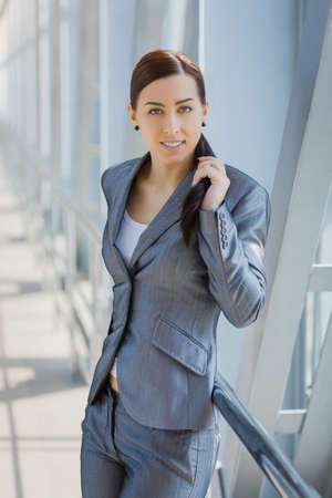 Portrait of pretty businesswoman on the modern backgroundの写真素材