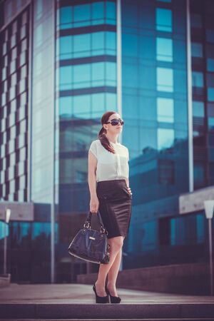 Business woman walking outside in city. office worker in downtown.の写真素材