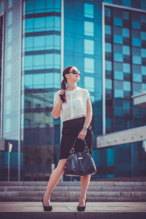 Business woman walking outside in city. office worker in downtown.の写真素材